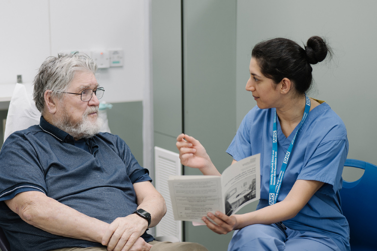 Adult outpatient appointments image of a nurse talking to a adult man