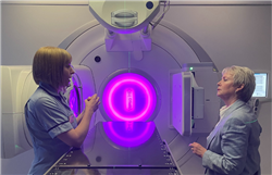 UHBW Radiographer Miranda discusses LINACs with Minister Smyth in front of a new LINAC 