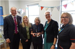 Sarah holding her Chief Midwifery Officer Silver Award 