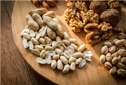 A wooden board covered with nuts