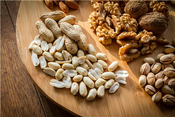 A wooden board covered with nuts