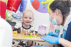 Young child at a table with a nurse